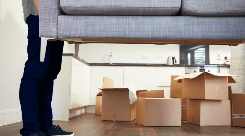 a boy lifting sofa in home shifting